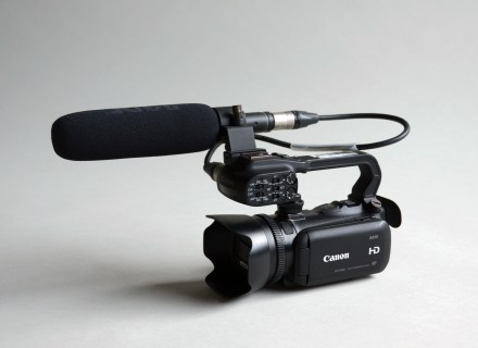Photo of the Canon XA10 on a grey background.