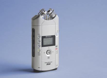 Image of Zoom H4 audio recorder standing upright on a blue background