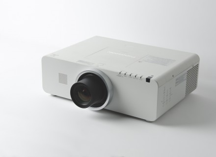 Photo of a projector sitting on a white surface